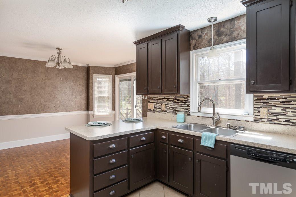 1605 Pagan Road Raleigh, NC 27603 - Photo 10 of 23 a kitchen with a sink window and cabinets