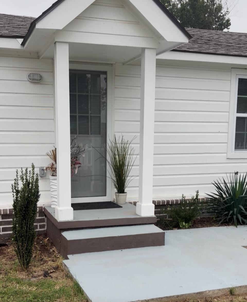 4769 West Union Road Millington, TN 38053 - Photo 3 of 12 White horizontal siding exterior with a covered entry