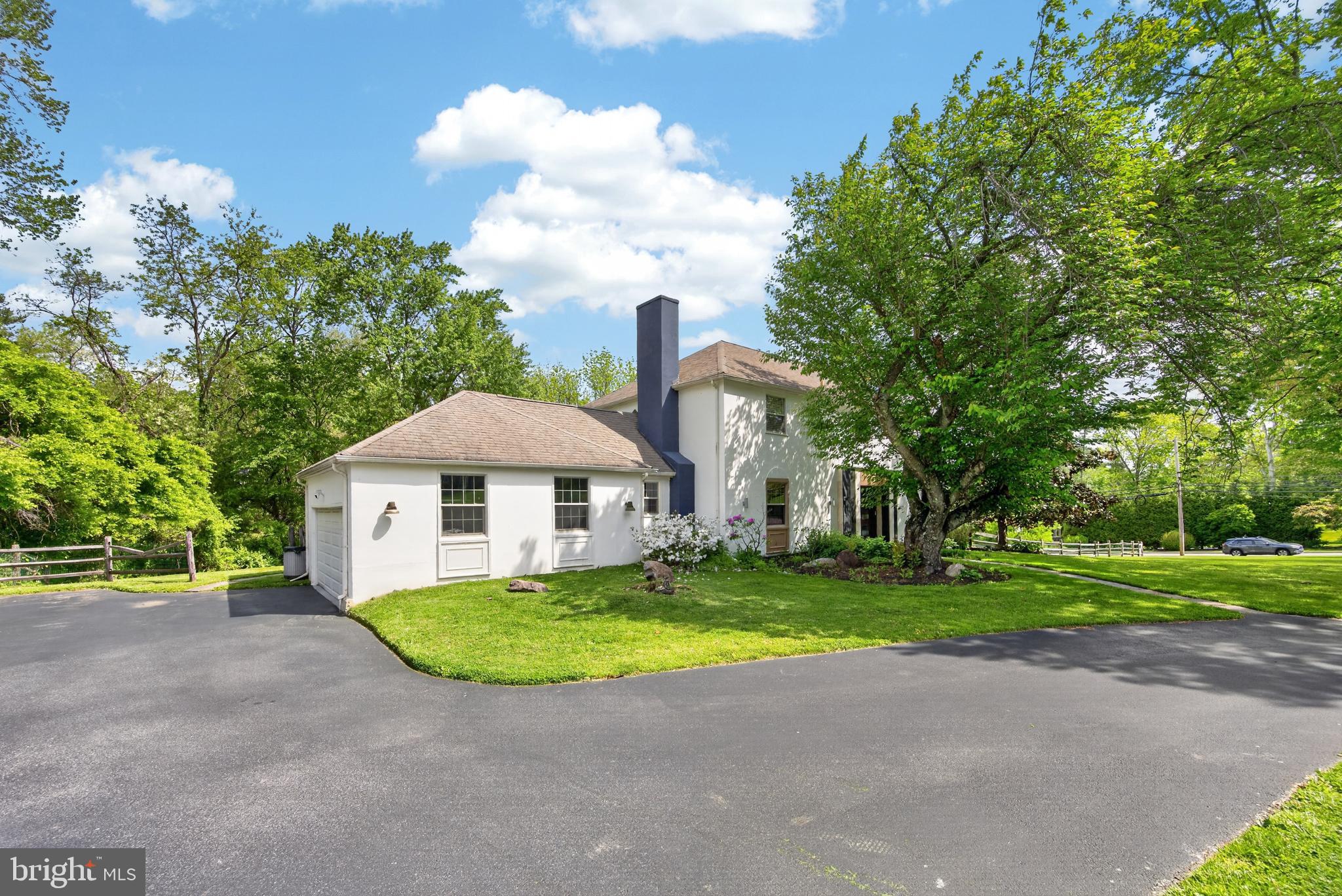 700 Campwoods Road Villanova, PA 19085 - Photo 2 of 77 a view of a house with a yard and large trees