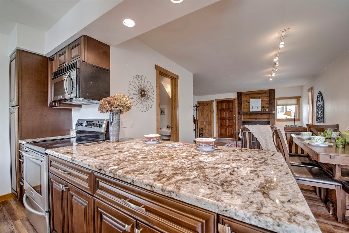 a living room with kitchen island granite countertop furniture and a kitchen view