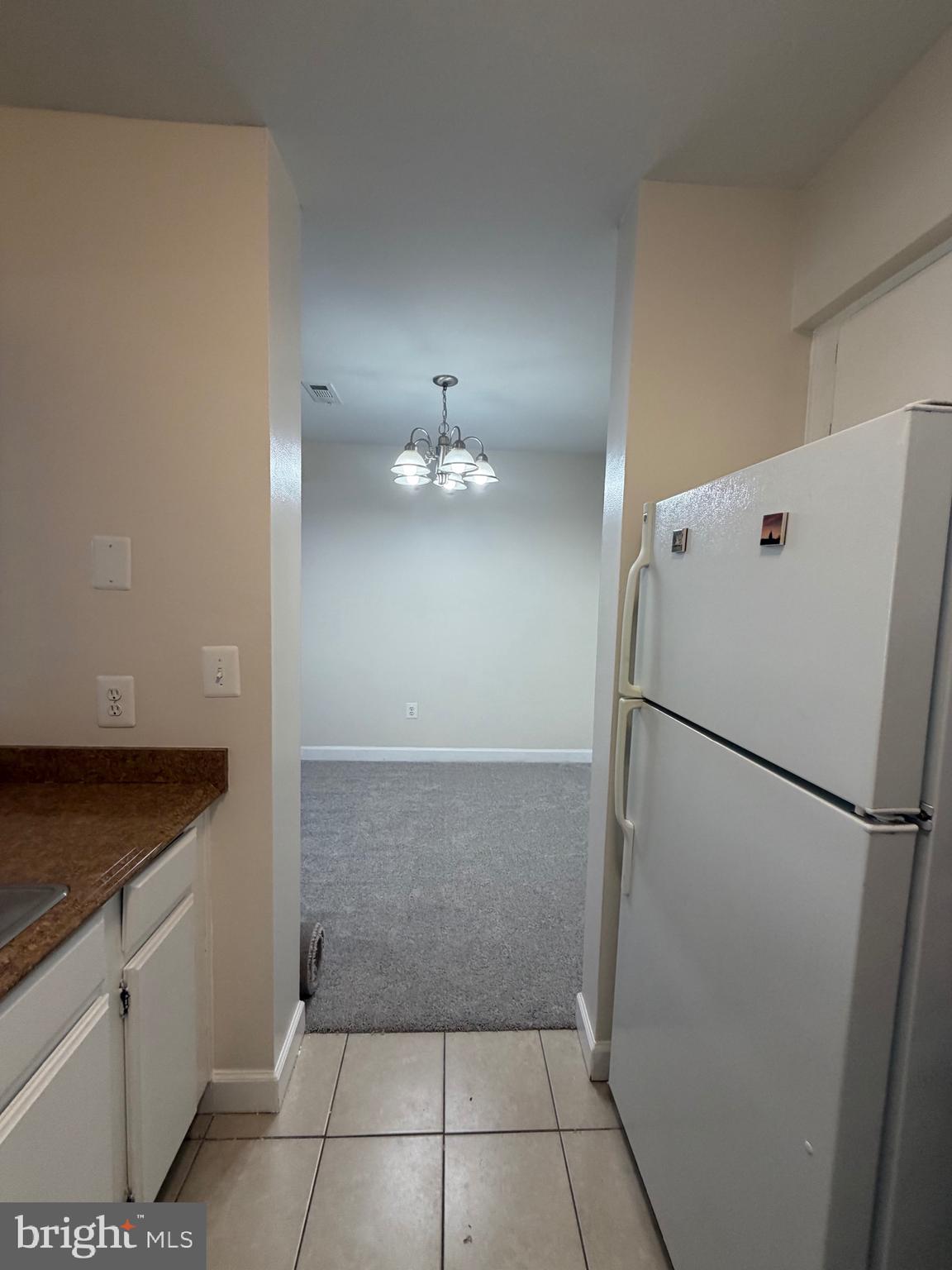 4118 Peppertree Lane, Unit 4118 Silver Spring, MD 20906 - Photo 14 of 30 a view of a refrigerator in kitchen and cabinets