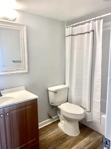 a bathroom with a toilet a sink and a mirror