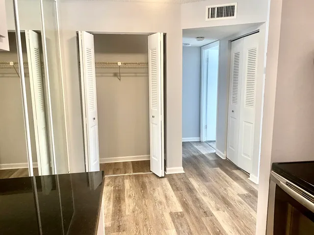 a view of a bathroom with wooden floor and a sink