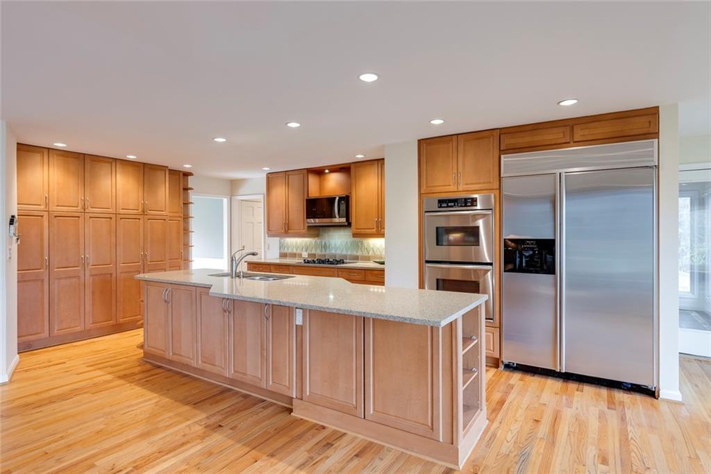 1416 Vernon Ridge Close Atlanta, GA 30338 - Photo 18 of 59 a kitchen with stainless steel appliances a refrigerator and a stove top oven