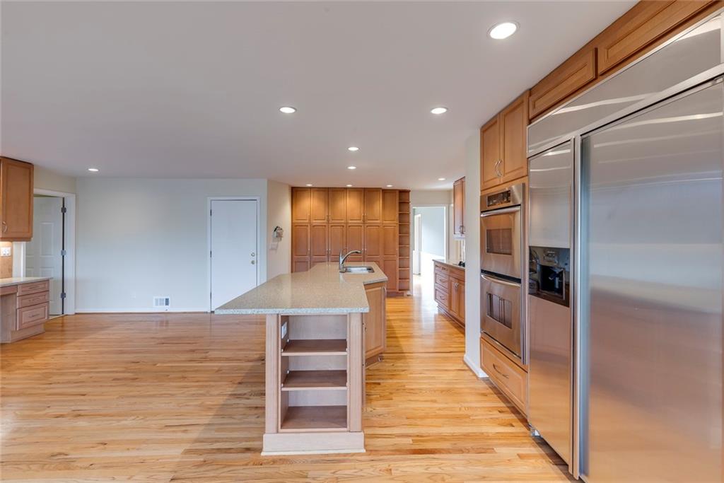 1416 Vernon Ridge Close Atlanta, GA 30338 - Photo 19 of 59 a open kitchen with white cabinets and stainless steel appliances