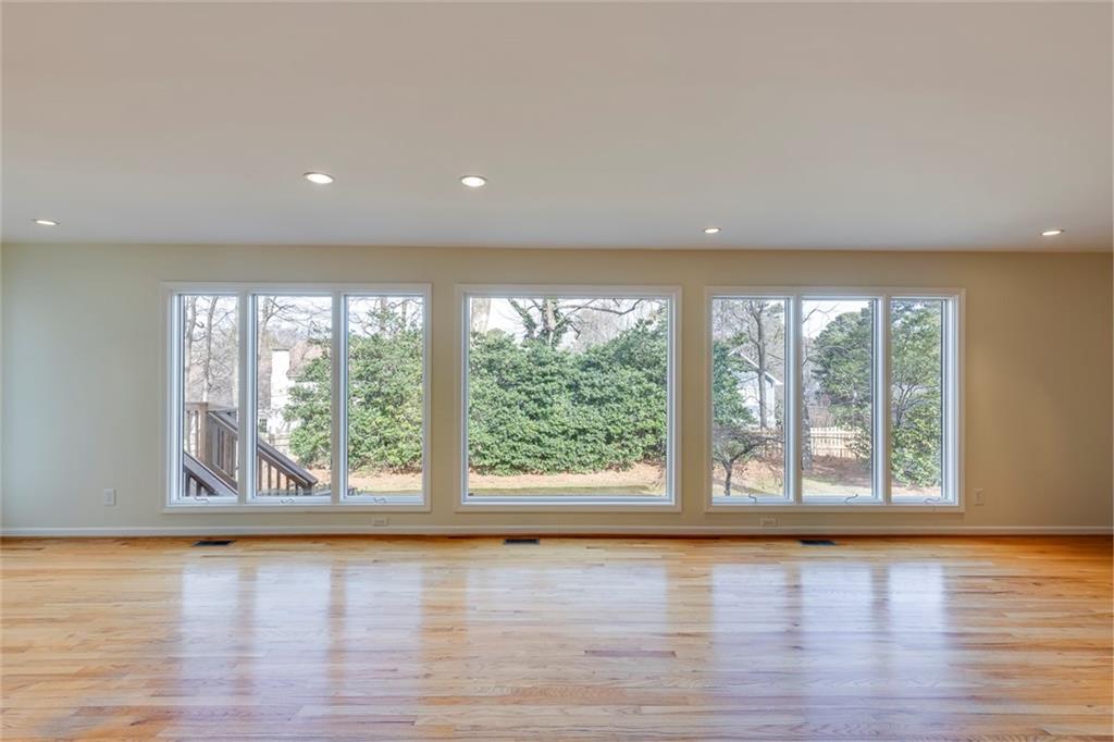 1416 Vernon Ridge Close Atlanta, GA 30338 - Photo 23 of 59 a view of an empty room with wooden floor and a window