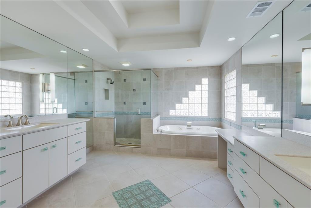 1416 Vernon Ridge Close Atlanta, GA 30338 - Photo 32 of 59 a large bathroom with a double vanity sink a large mirror and a bathtub