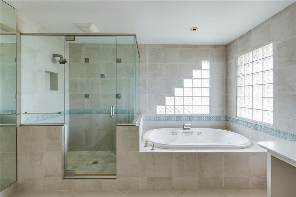 1416 Vernon Ridge Close Atlanta, GA 30338 - Photo 33 of 59 a bathroom with a shower and a sink