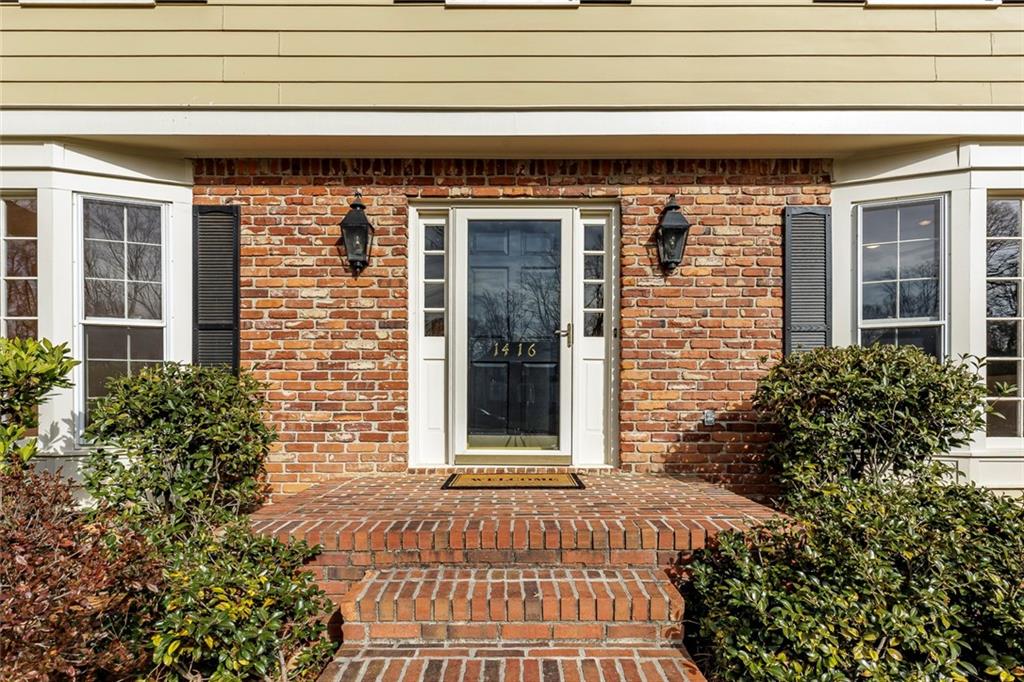 1416 Vernon Ridge Close Atlanta, GA 30338 - Photo 4 of 59 a front view of a house with a lots of plants and flowers
