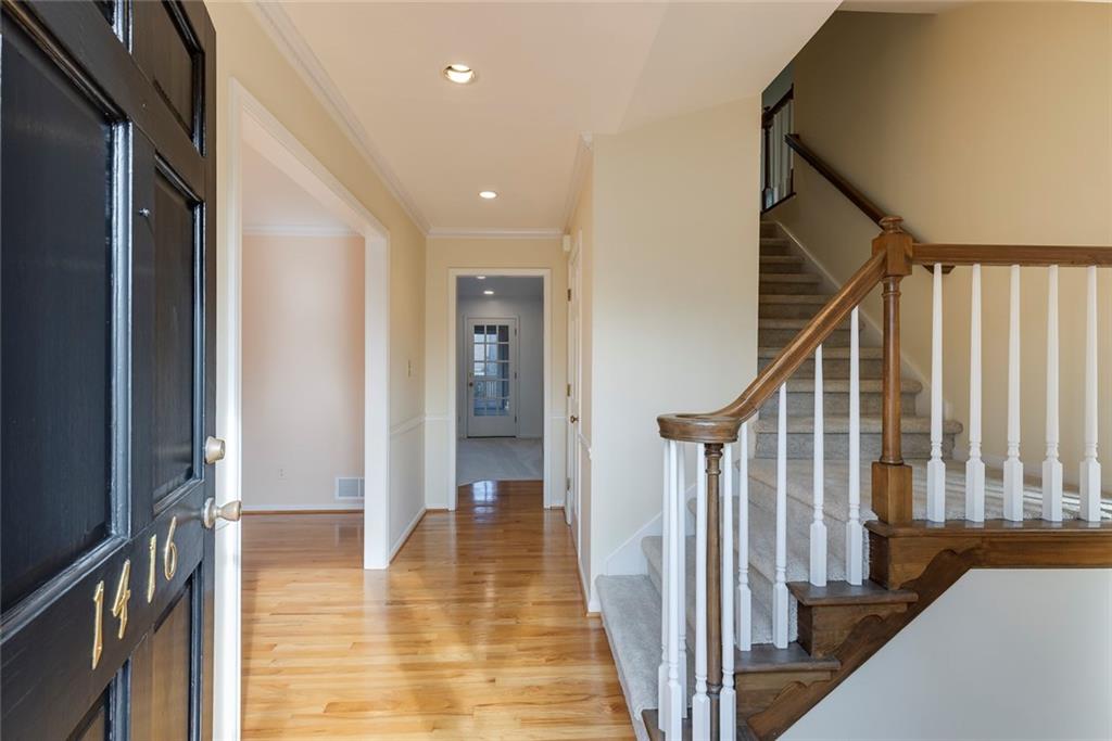 1416 Vernon Ridge Close Atlanta, GA 30338 - Photo 5 of 59 a view of a hallway with wooden floor and staircase