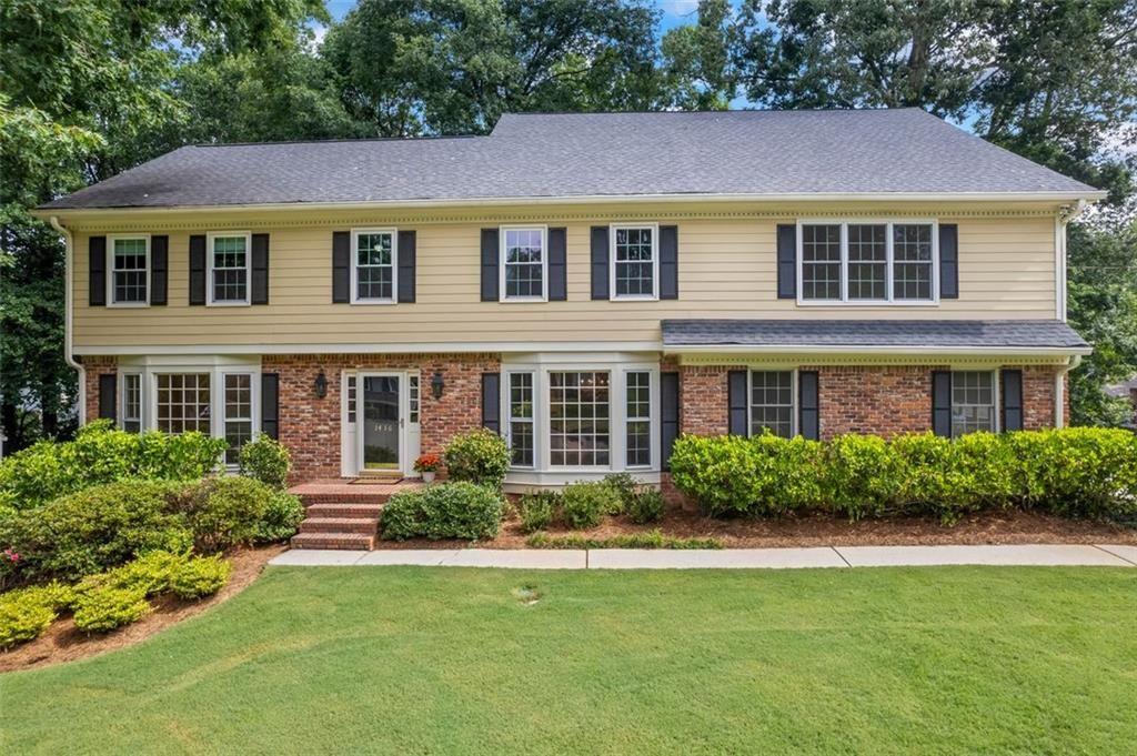 1416 Vernon Ridge Close Atlanta, GA 30338 - Photo 59 of 59 a front view of a house with a yard and porch