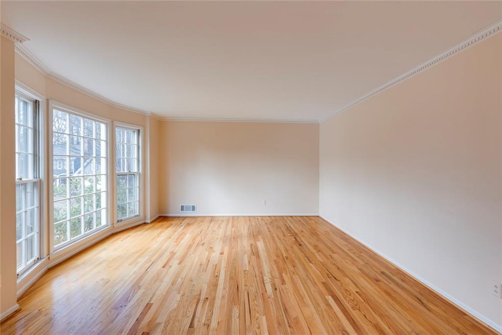 1416 Vernon Ridge Close Atlanta, GA 30338 - Photo 6 of 59 a view of an empty room with wooden floor and a window