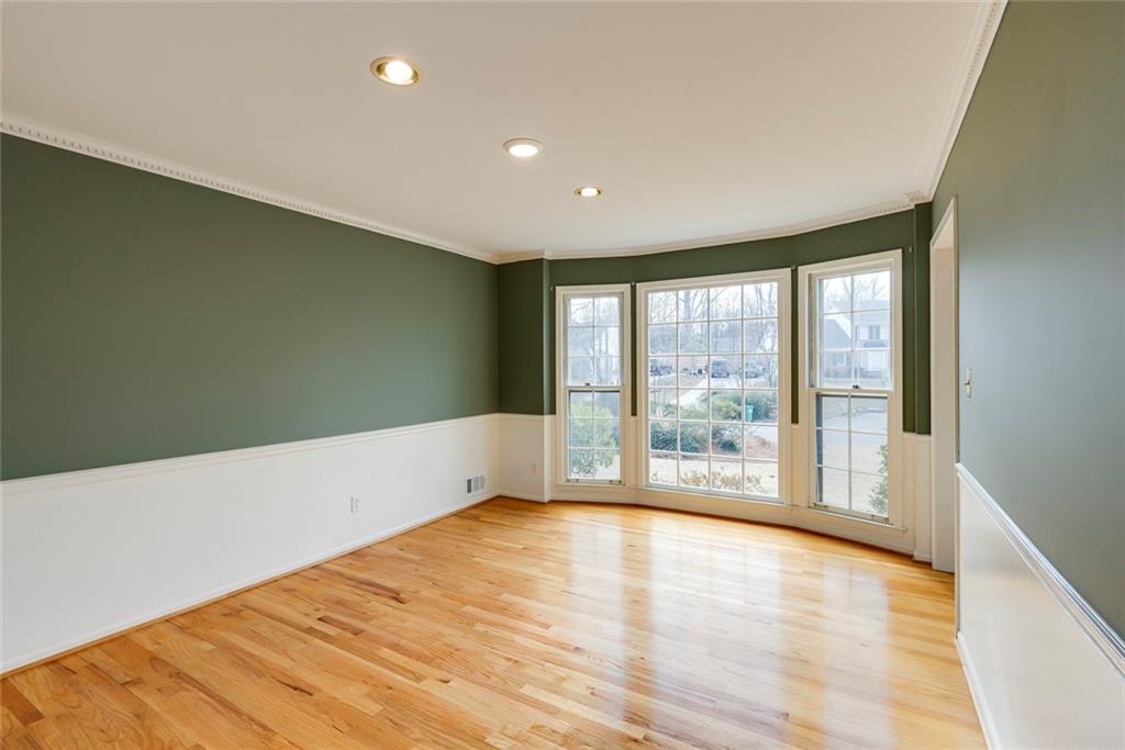 1416 Vernon Ridge Close Atlanta, GA 30338 - Photo 9 of 59 a view of an empty room with wooden floor and a window