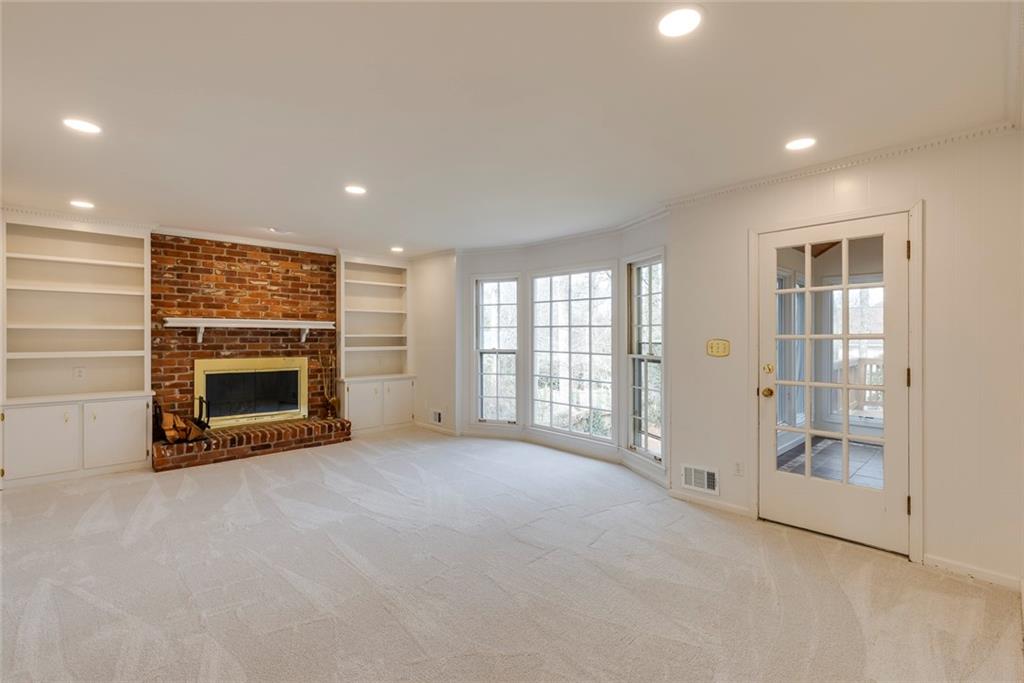 1416 Vernon Ridge Close Atlanta, GA 30338 - Photo 10 of 59 an empty room with windows and fireplace