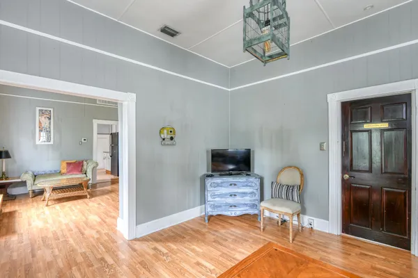 a bedroom with a bed and large windows