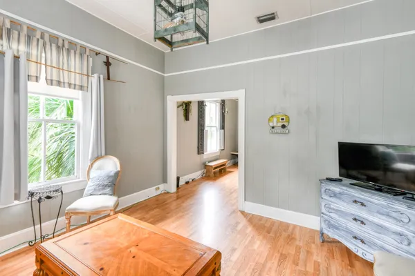 a bedroom with a bed and wooden floor