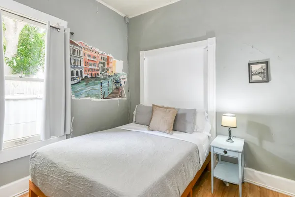 a bedroom with a bed and flat screen tv