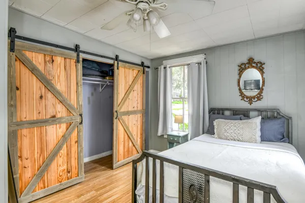 a kitchen with stainless steel appliances kitchen island granite countertop a table chairs in it and wooden floors