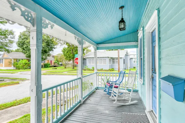 a living room with furniture a chandelier and a window