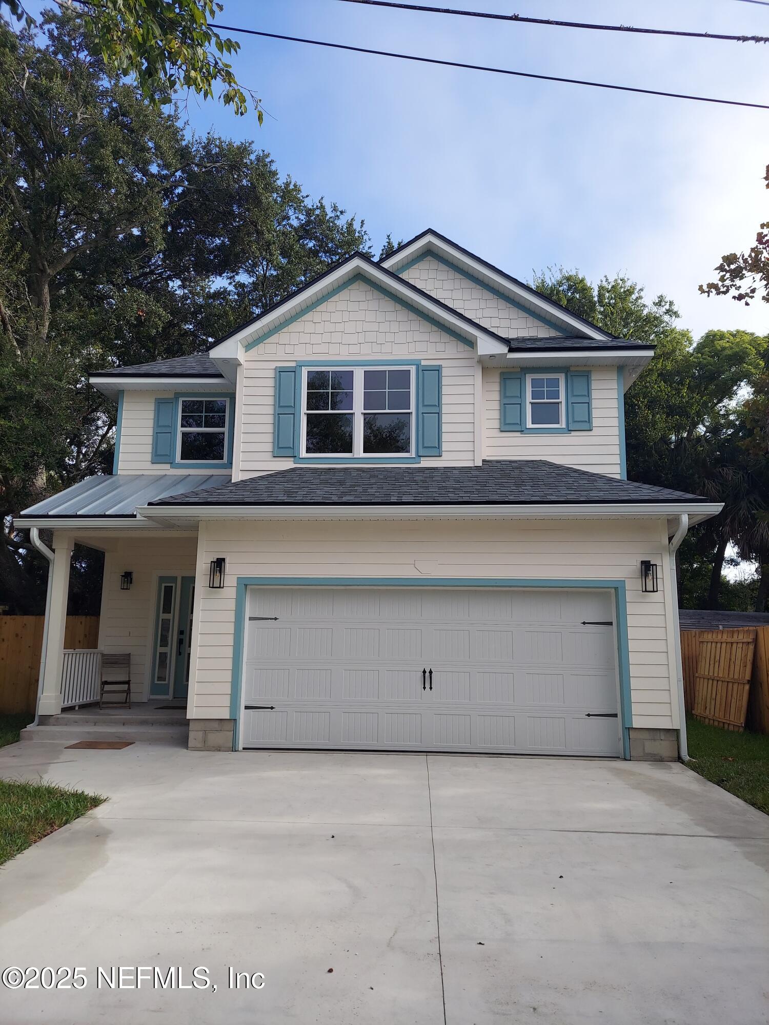 1337 Roxie Street Atlantic Beach, FL 32233 - Photo 1 of 6 a front view of a house with a garage