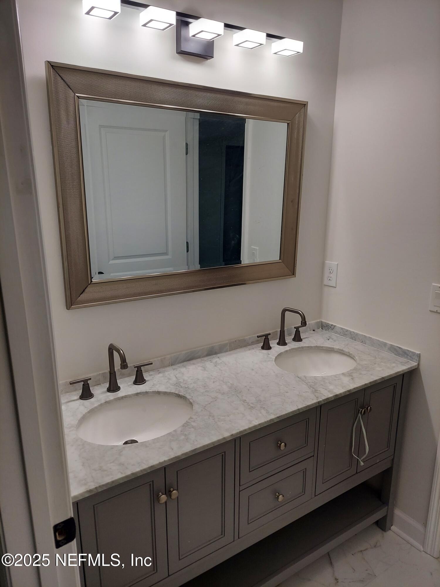 1337 Roxie Street Atlantic Beach, FL 32233 - Photo 5 of 6 a bathroom with a sink and a mirror
