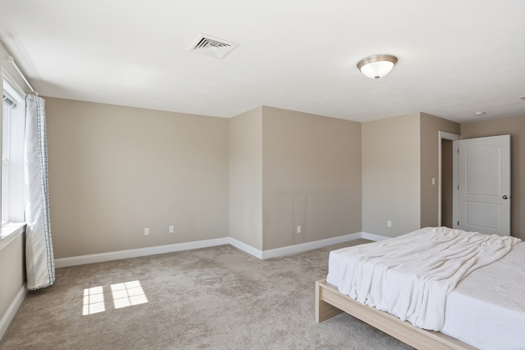 2 Dino Way, Unit 52 Milford, MA 01757 - Photo 21 of 41 a bedroom with a bed and a window