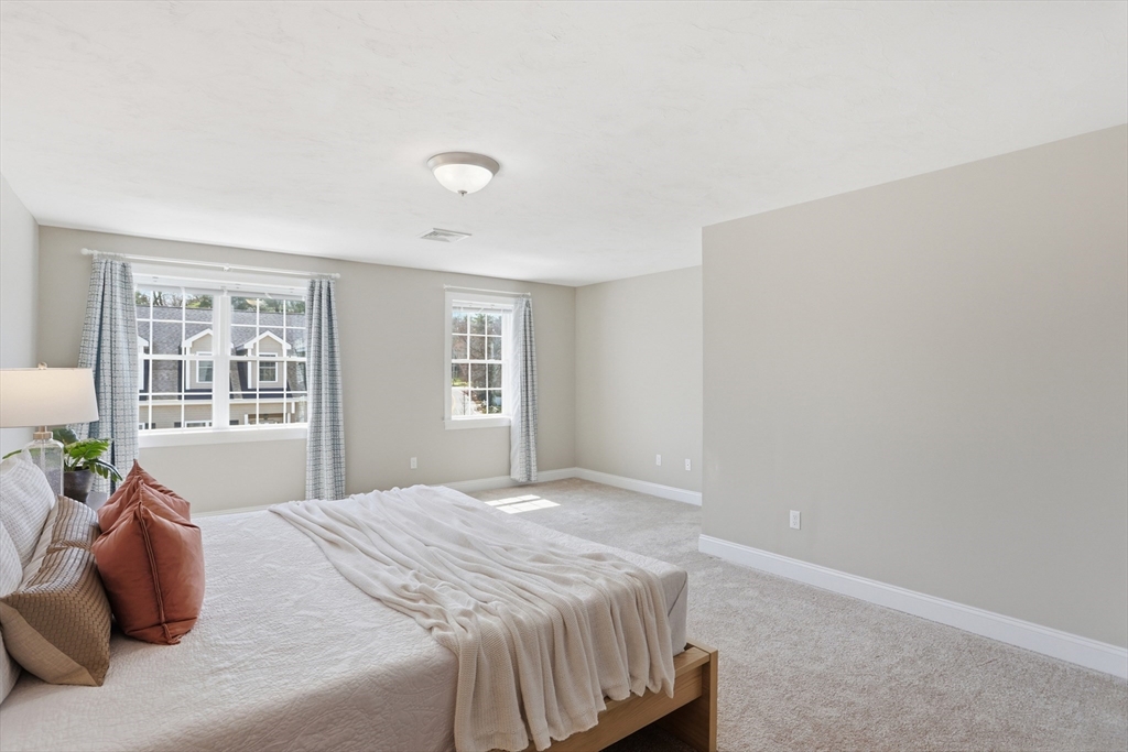 2 Dino Way, Unit 52 Milford, MA 01757 - Photo 22 of 41 a bedroom with a bed and glass window