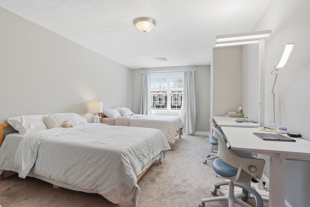 2 Dino Way, Unit 52 Milford, MA 01757 - Photo 23 of 41 a bedroom with two beds and a table