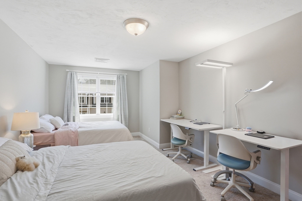 2 Dino Way, Unit 52 Milford, MA 01757 - Photo 24 of 41 a bedroom with a bed and a desk
