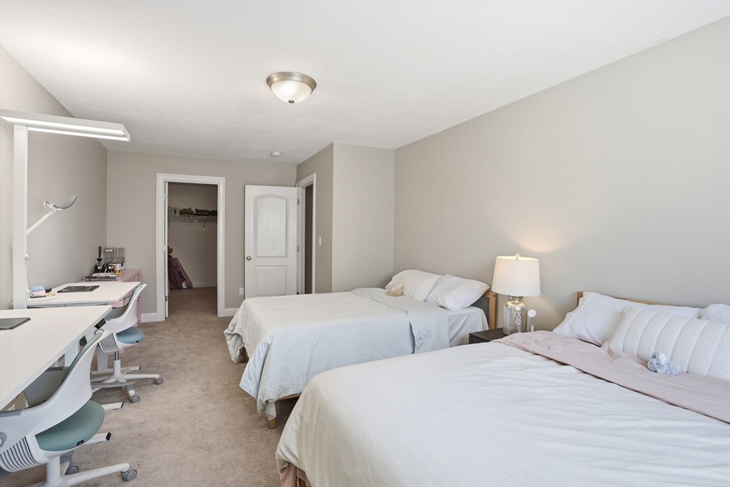 2 Dino Way, Unit 52 Milford, MA 01757 - Photo 25 of 41 a bedroom with two bed and a desk