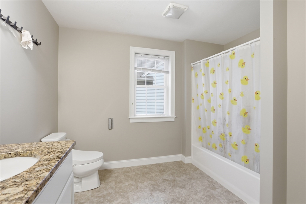 2 Dino Way, Unit 52 Milford, MA 01757 - Photo 28 of 41 a bathroom with a granite countertop sink a toilet and a shower