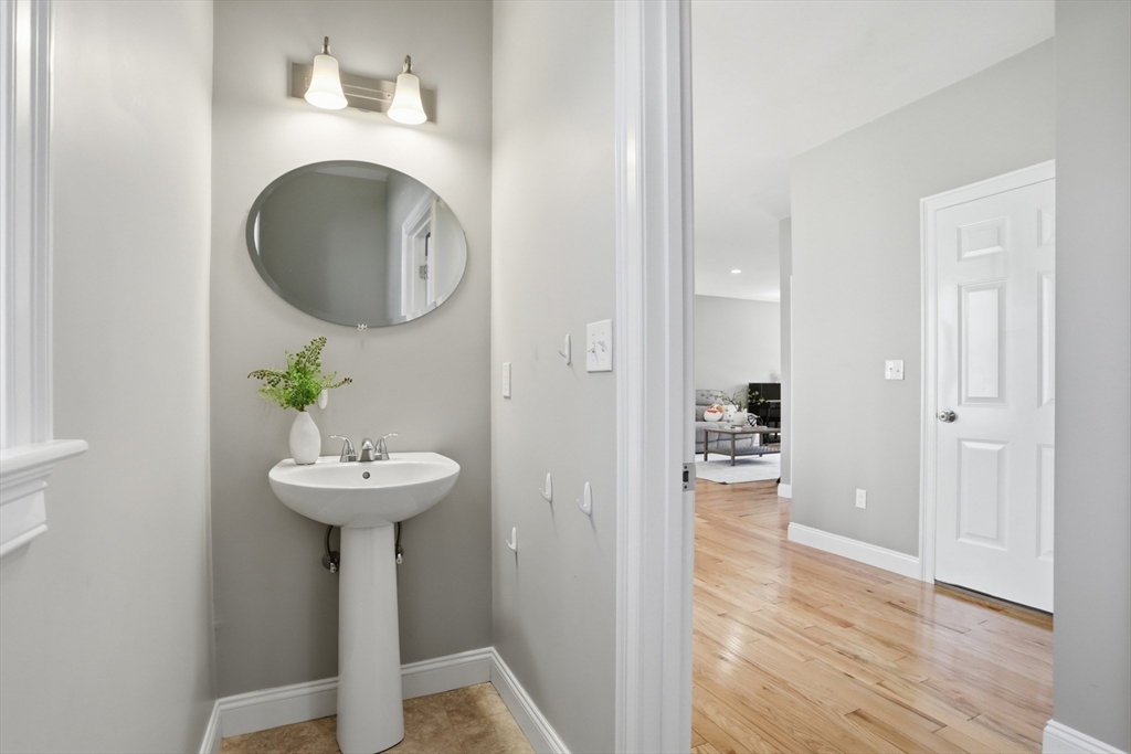 2 Dino Way, Unit 52 Milford, MA 01757 - Photo 29 of 41 a view of a hallway with wooden floor and a sink