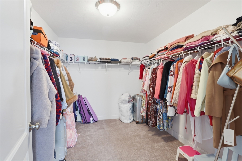 2 Dino Way, Unit 52 Milford, MA 01757 - Photo 30 of 41 a view of walk in closet with clothes