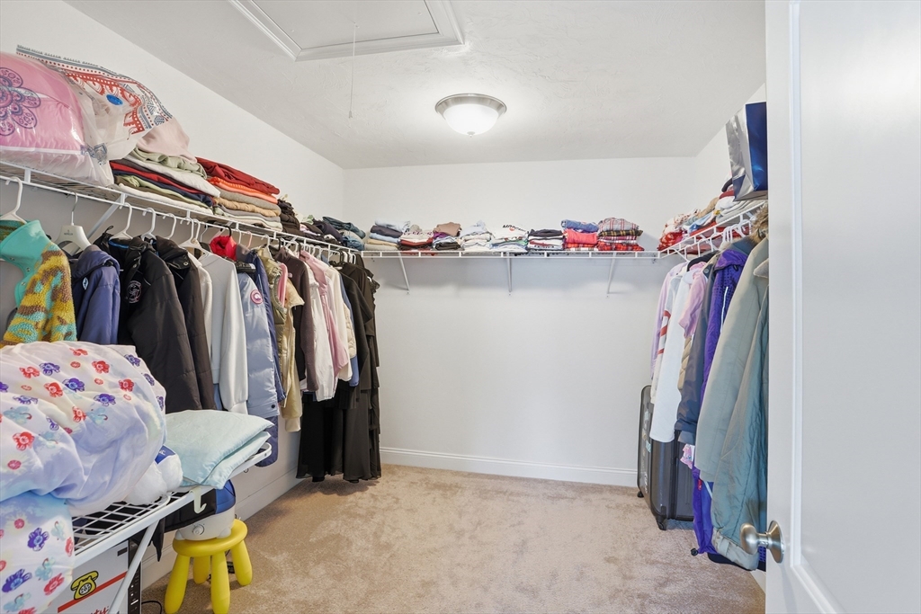 2 Dino Way, Unit 52 Milford, MA 01757 - Photo 31 of 41 a view of walk in closet with clothes and shoes