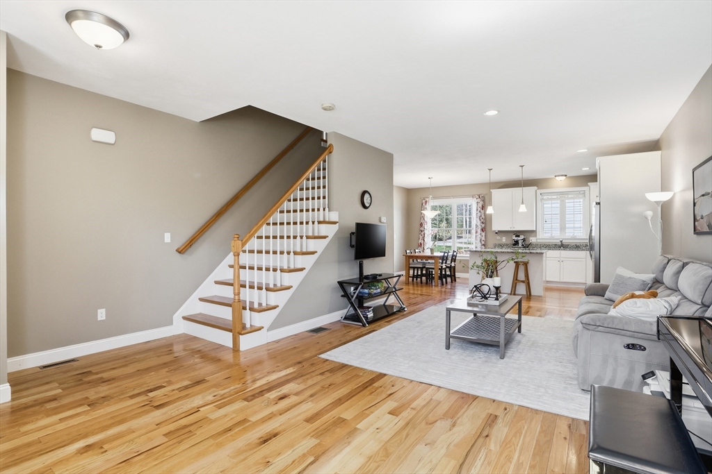 2 Dino Way, Unit 52 Milford, MA 01757 - Photo 5 of 41 a living room with furniture and a wooden floor