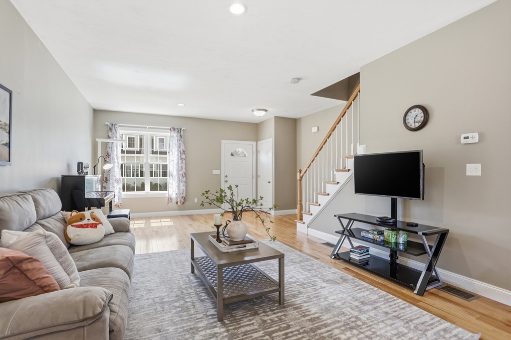 2 Dino Way, Unit 52 Milford, MA 01757 - Photo 7 of 41 a living room with furniture and a flat screen tv