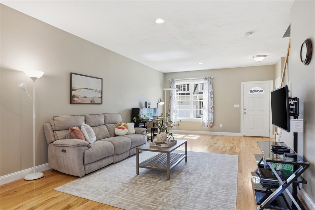 2 Dino Way, Unit 52 Milford, MA 01757 - Photo 8 of 41 a living room with furniture and a flat screen tv