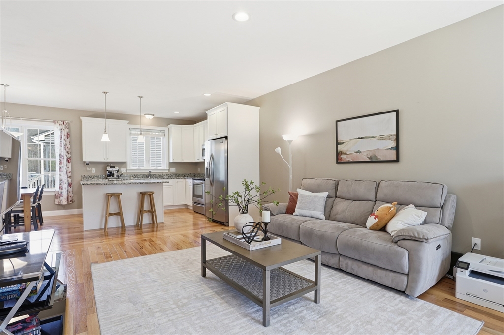 2 Dino Way, Unit 52 Milford, MA 01757 - Photo 10 of 41 a living room with furniture and kitchen view