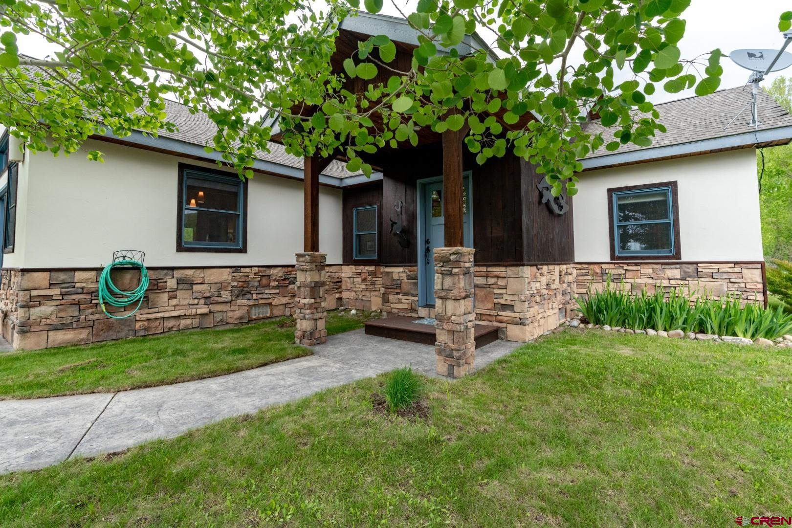 a front view of house with yard and green space