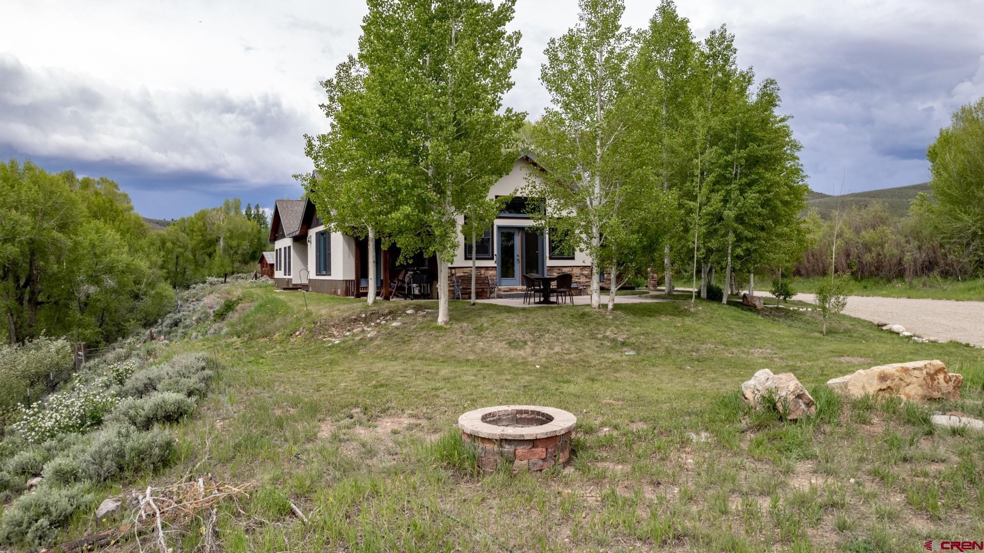 305 Roper Lane Almont, CO 81210 - Photo 2 of 35 a backyard of a house with table and chairs