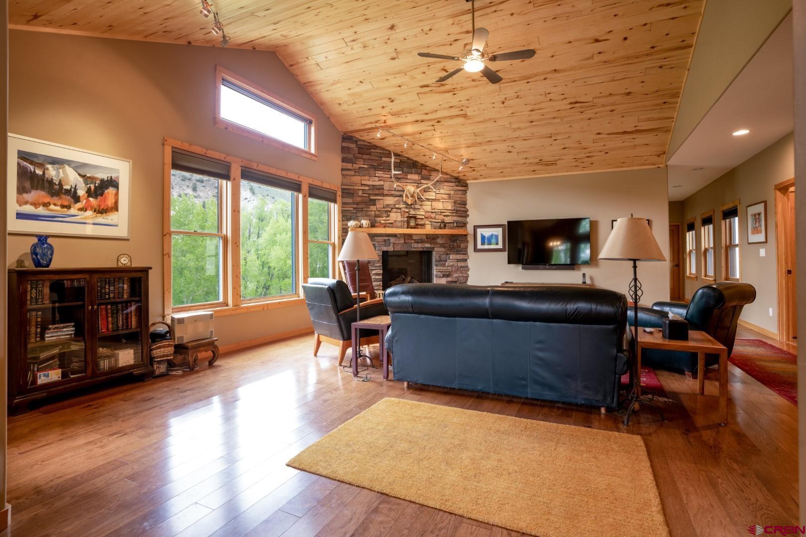 305 Roper Lane Almont, CO 81210 - Photo 22 of 35 a living room with furniture a fireplace and a flat screen tv