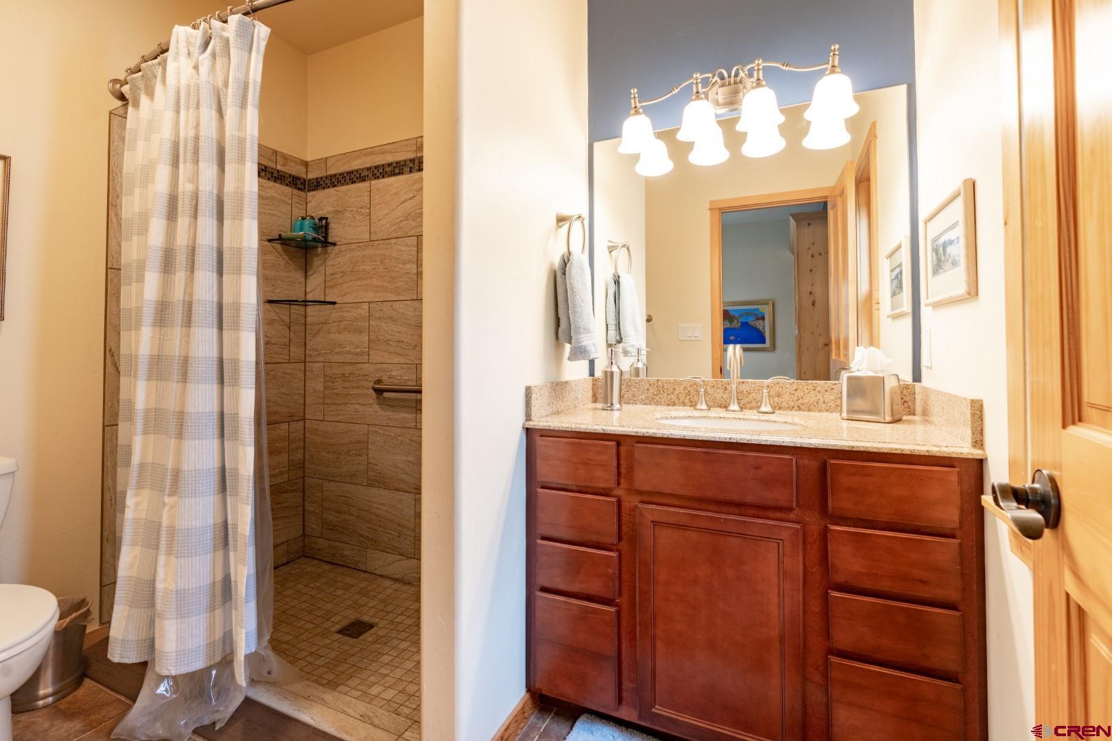 305 Roper Lane Almont, CO 81210 - Photo 27 of 35 a bathroom with a double vanity sink mirror and shower
