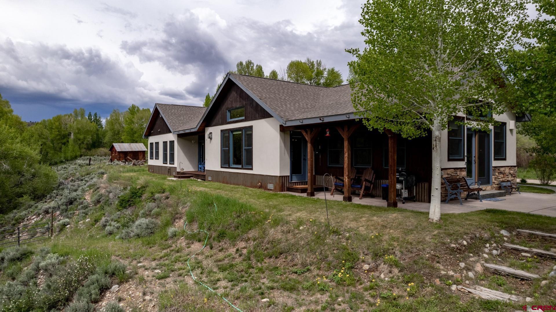 305 Roper Lane Almont, CO 81210 - Photo 3 of 35 a view of a house with a yard and sitting area