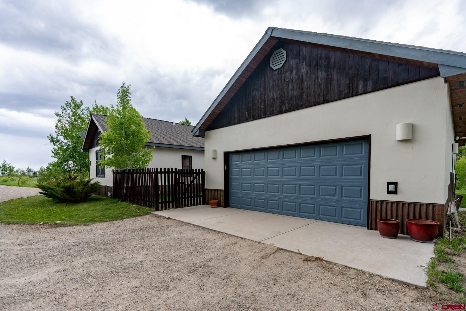 305 Roper Lane Almont, CO 81210 - Photo 9 of 35 a view of a house with a yard and garage