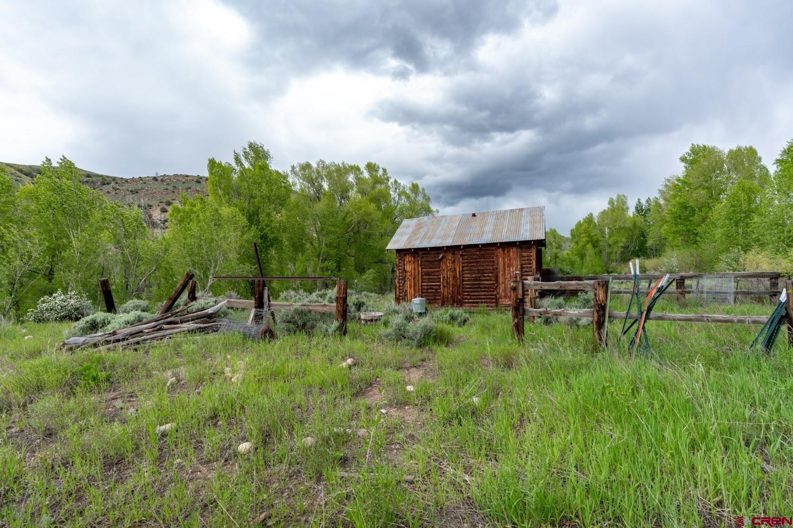 305 Roper Lane Almont, CO 81210 - Photo 10 of 35 a backyard of a house with table and chairs