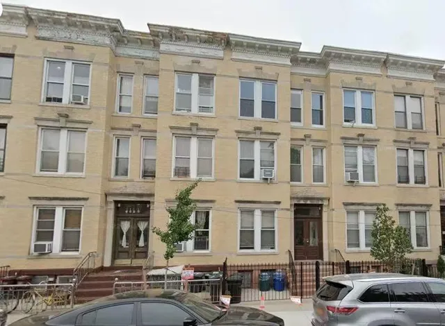 a couple of cars parked in front of a building