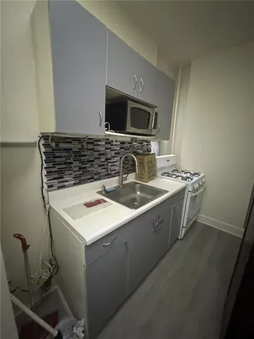 a kitchen with a sink stove and microwave