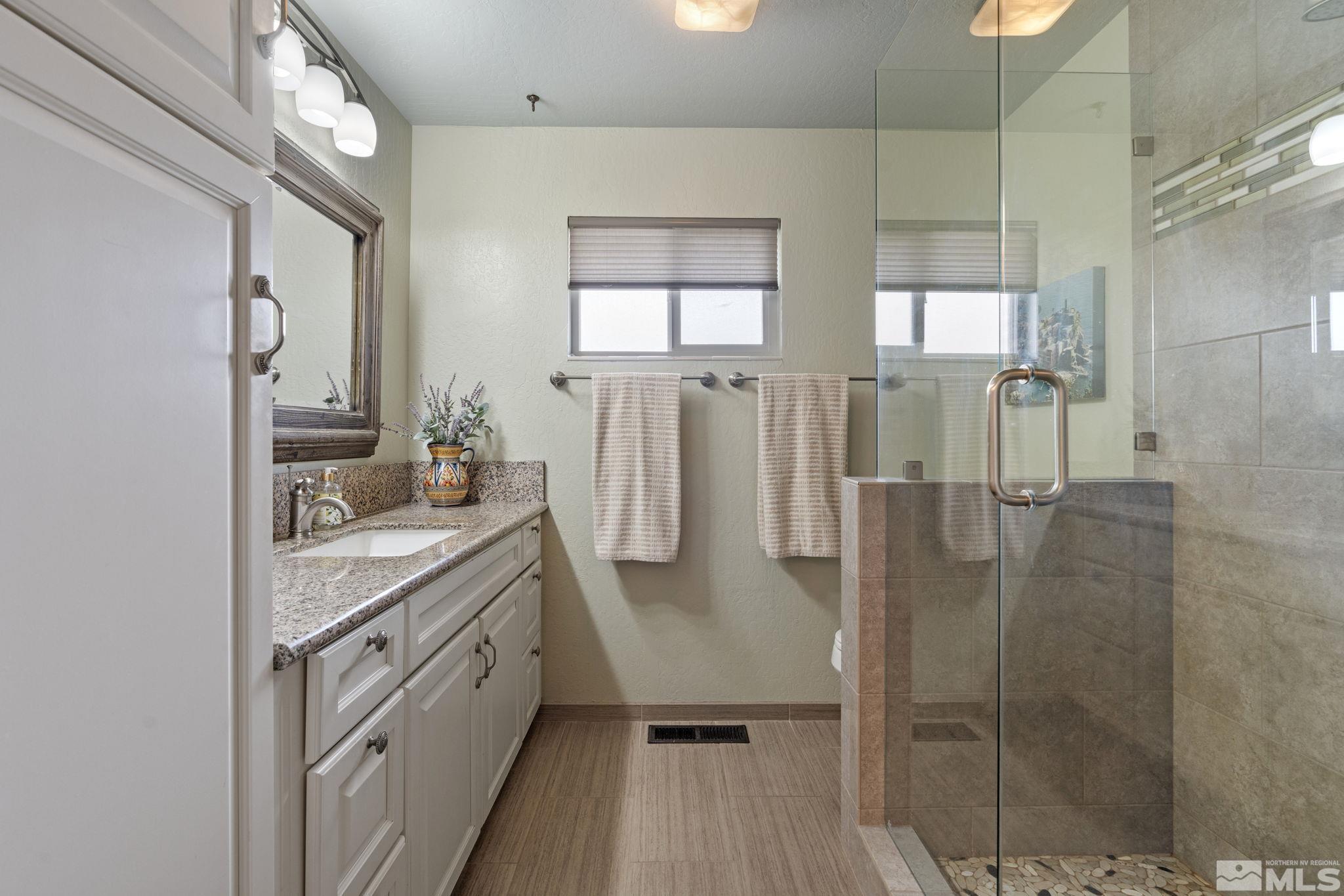 690 Shamrock Lane Reno, NV 89509 - Photo 18 of 30 a bathroom with double vanity and a shower