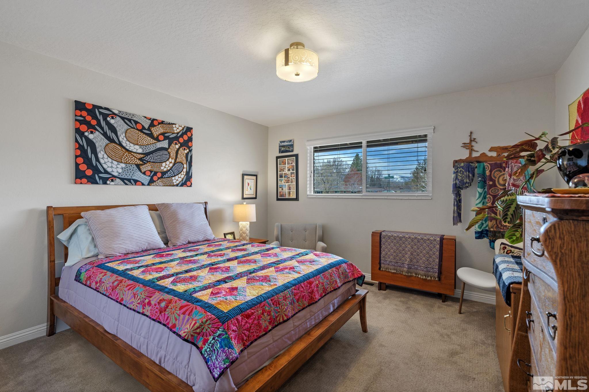 690 Shamrock Lane Reno, NV 89509 - Photo 20 of 30 a bedroom with a bed and a chandelier