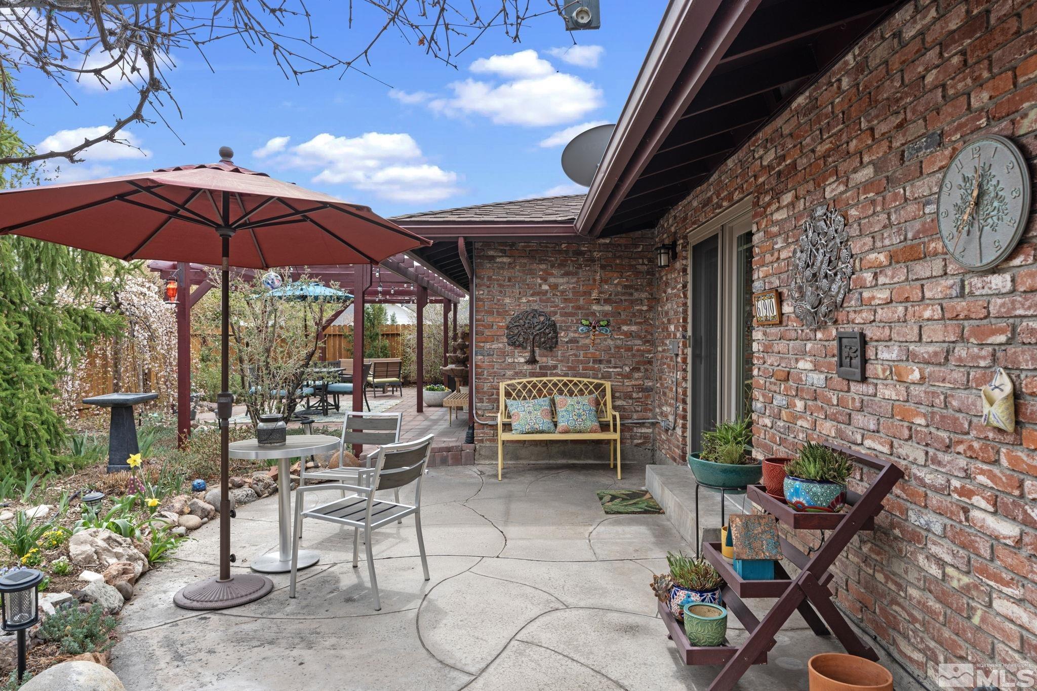 690 Shamrock Lane Reno, NV 89509 - Photo 23 of 30 a patio with a table and chairs under an umbrella